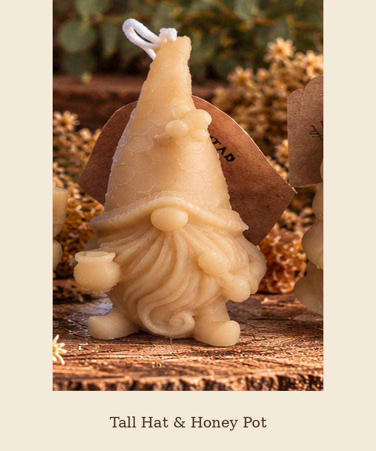 Beeswax gnome candle with a tall pointed hat holding a honey pot, labeled Tall Hat & Honey Pot