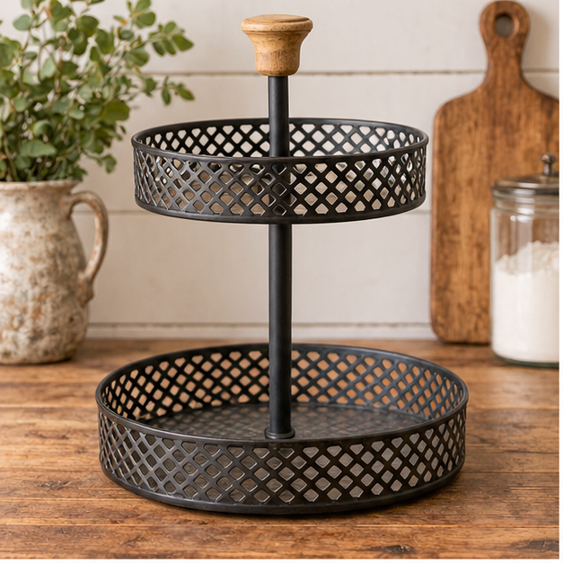 Empty black two-tier display stand with wooden handle on a rustic kitchen counter