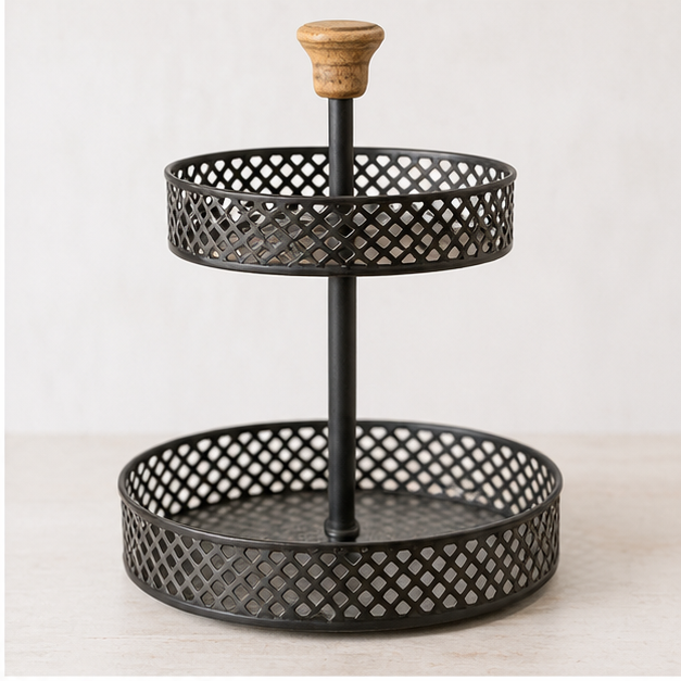 Empty two-tier black metal stand with diamond-pattern tray sides against a light background