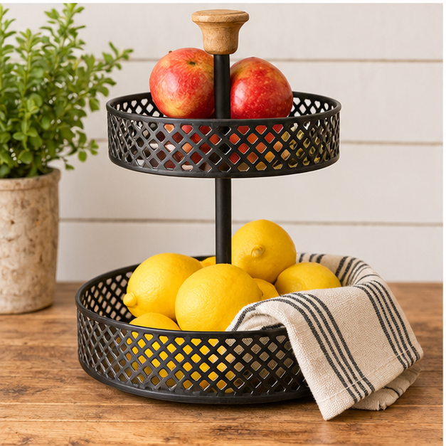 Black two-tier countertop stand displaying red apples and yellow lemons with a striped cloth