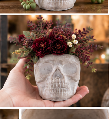 Gray cement sugar skull planter held in one hand and styled with burgundy flowers

