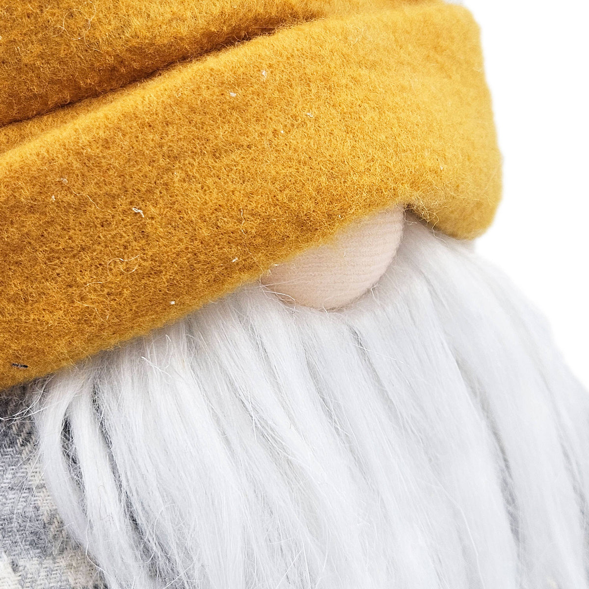 Close-up of the gnome’s mustard-yellow folded hat brim, cream nose, and long white beard.