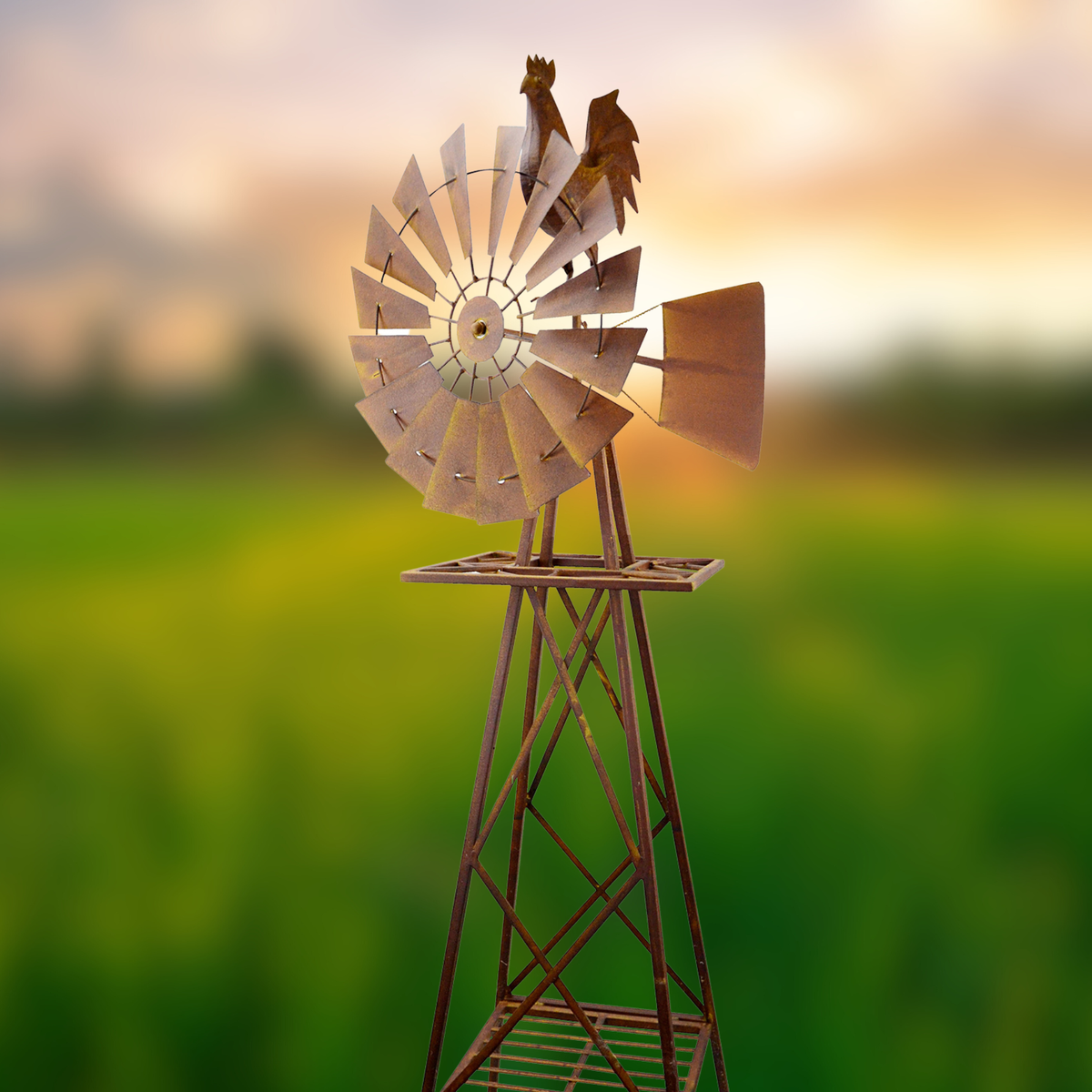 Rustic rooster windmill garden décor against a glowing sunset sky with green field background
