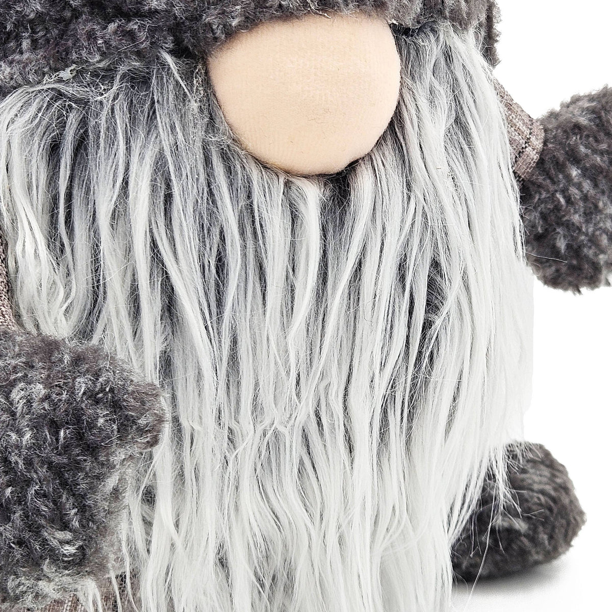 Close-up of the gnome’s cream nose, long gray-and-white beard, and textured gray knit mittens.