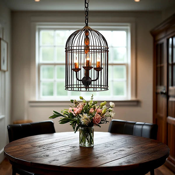 Rustic metal bird cage pendant lamp with distressed finish and candelabra bulb holders, hanging by chain in Rustic Kitchen Dining