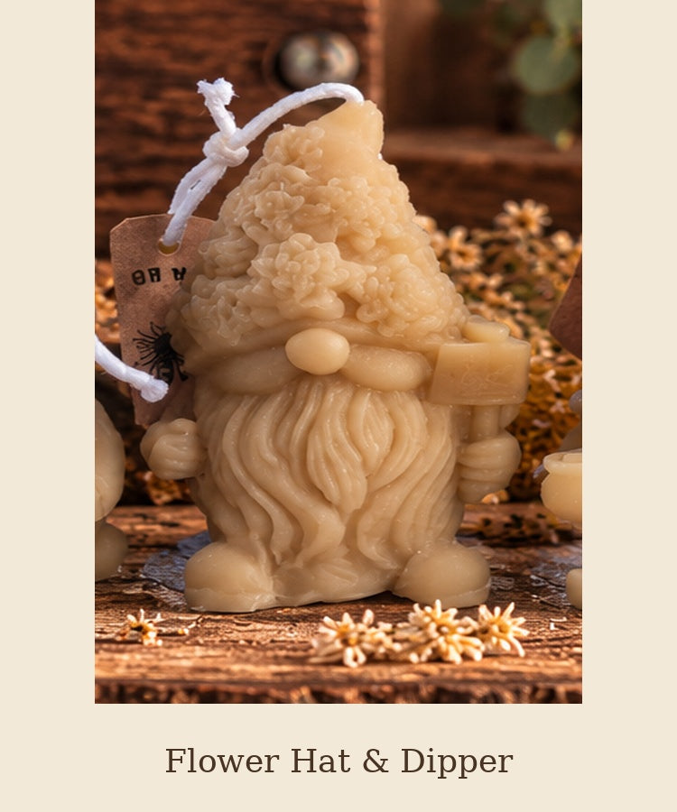 Beeswax gnome candle with a flower-covered hat and raised honey dipper, labeled Flower Hat & Dipper