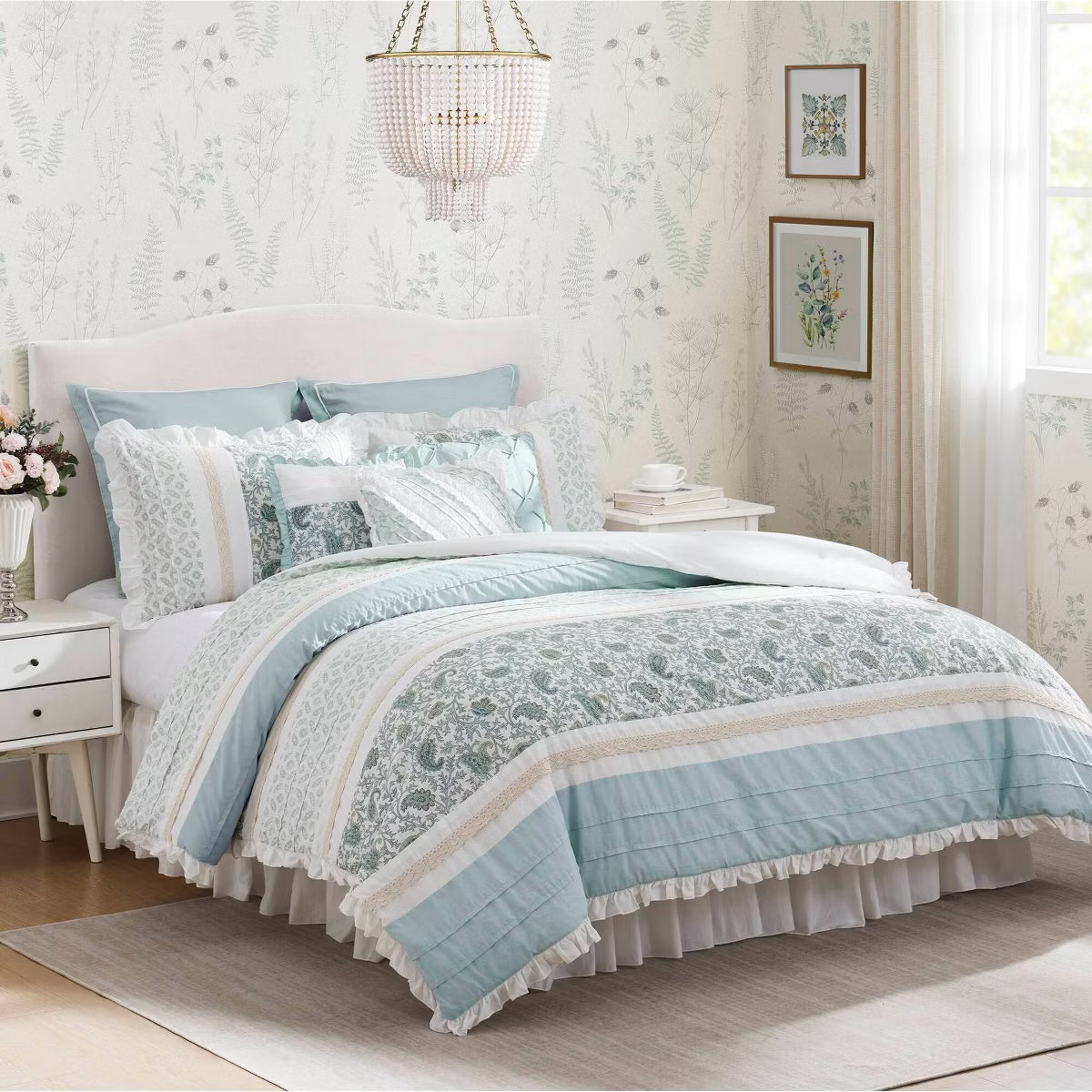 Madison Park Dawn Queen nine-piece comforter set in blue, cream, and white, styled with coordinating shams, decorative pillows, and a white bed skirt.