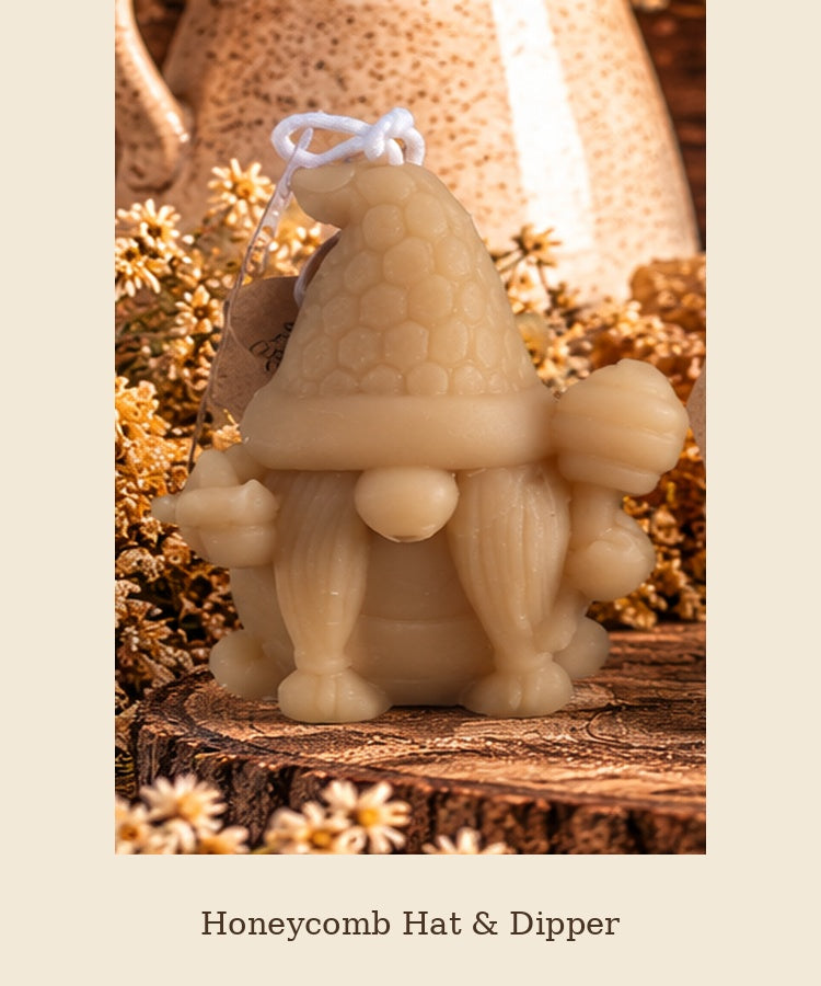 Beeswax gnome candle with a honeycomb-patterned hat and raised dipper, labeled Honeycomb Hat & Dipper