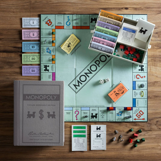 Monopoly Vintage Bookshelf Edition board game in fabric-wrapped book box with classic pewter tokens and wooden houses