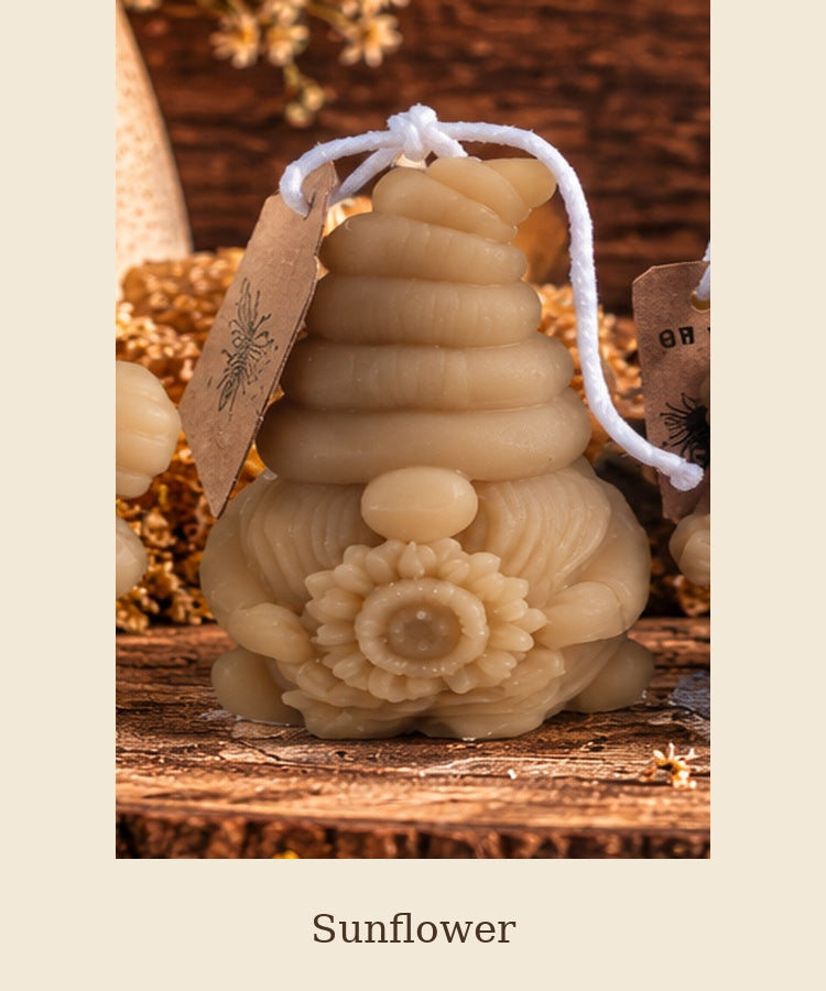 Beeswax gnome candle with a ribbed hat holding a sunflower, labeled Sunflower