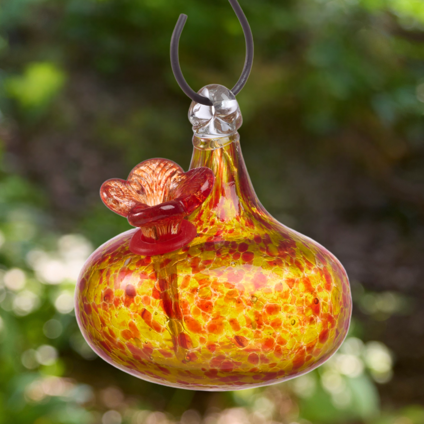 Yellow and red speckled art glass hummingbird feeder with red glass flower feeding port
