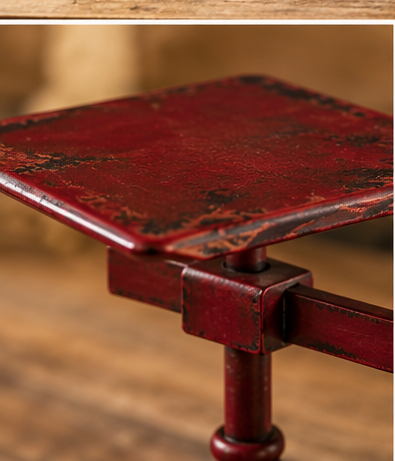 Close-up of the balance scale clock’s square decorative platform with worn red metal edges