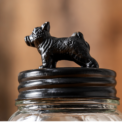 Close-up of the black metal bulldog topper and ridged lid on the glass dog treat jar