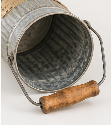Angled view into the empty metal Flowers & Plants can, showing its interior and wooden handle grip.