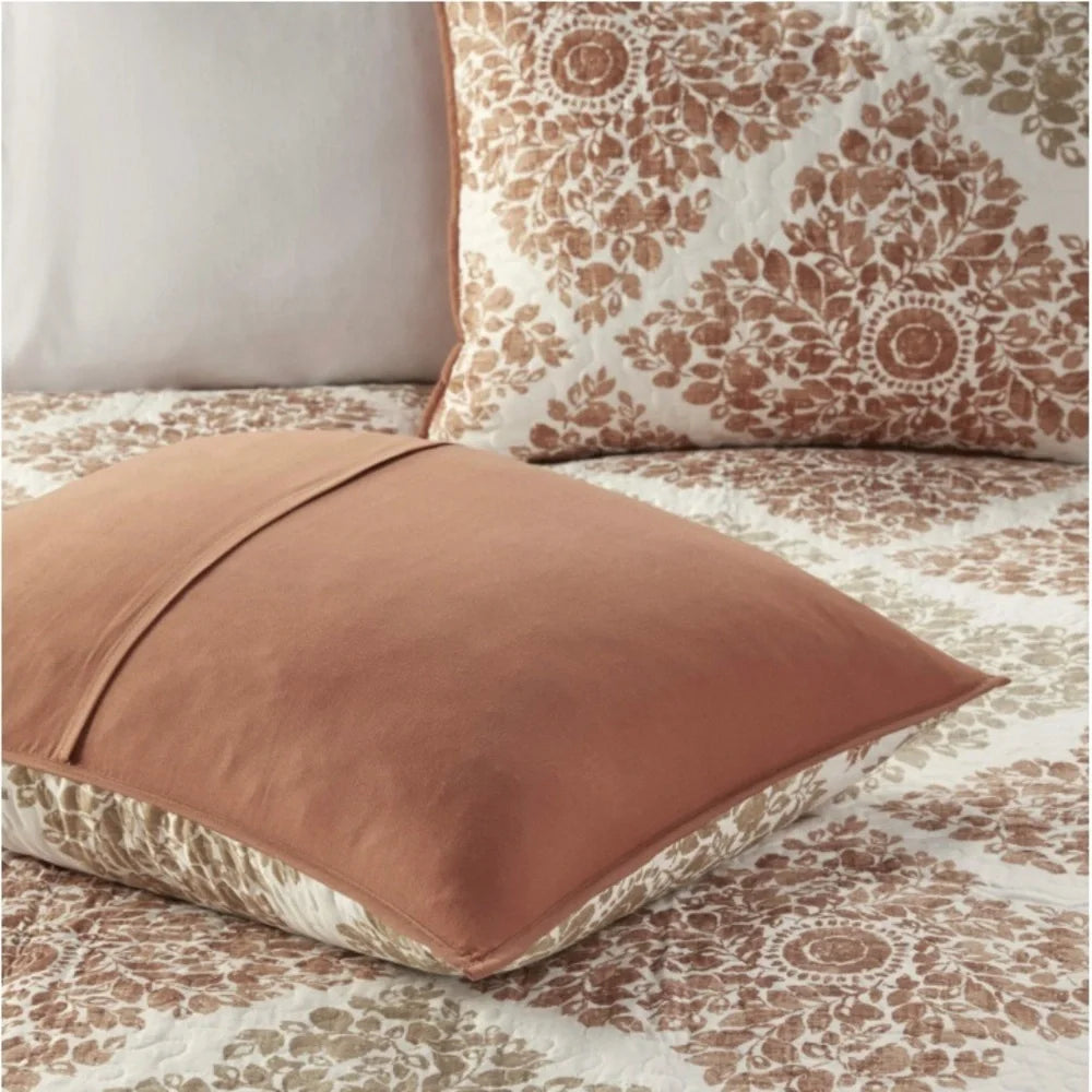 Reverse of a Madison Park Claire sham showing a solid spice-colored back and envelope closure.