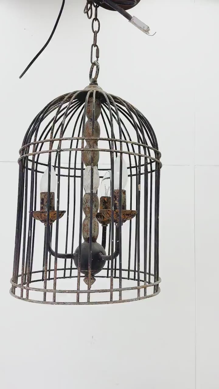 Rustic metal bird cage pendant lamp with distressed finish and candelabra bulb holders, hanging by chain video view